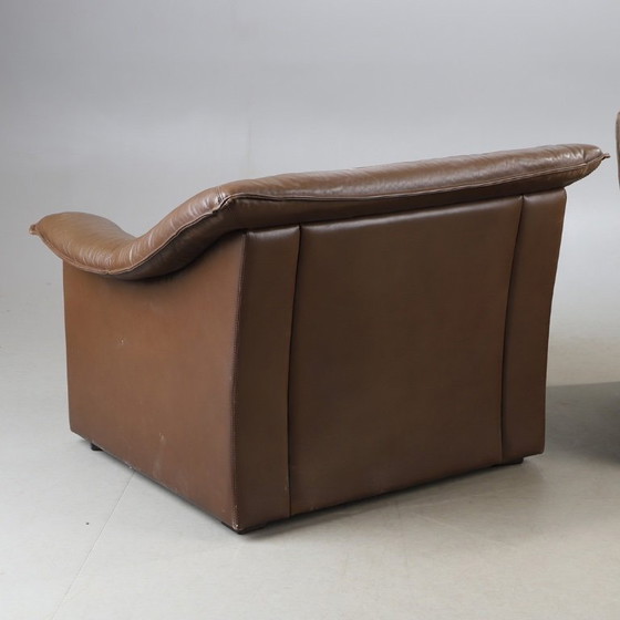 Image 1 of Pair of mid‑century brown leather club armchairs in good condition with small signs of aging and blemishes