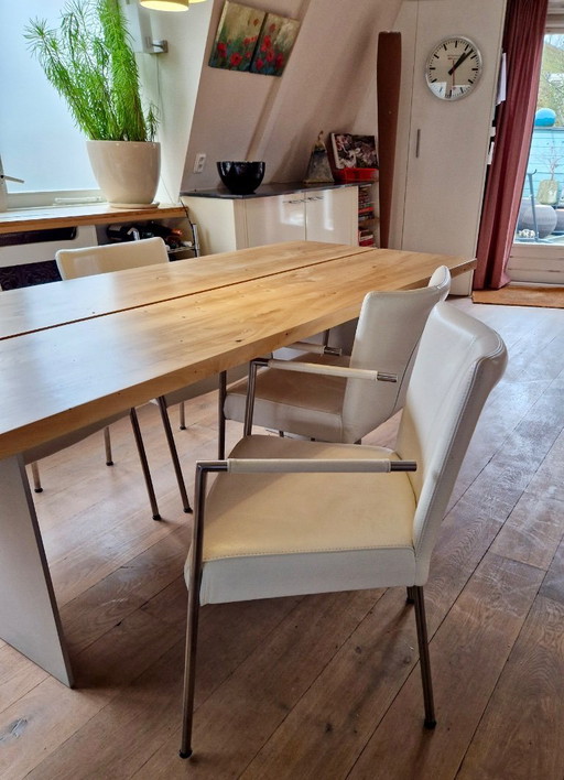 4 dining room chairs upholstered in white leather
