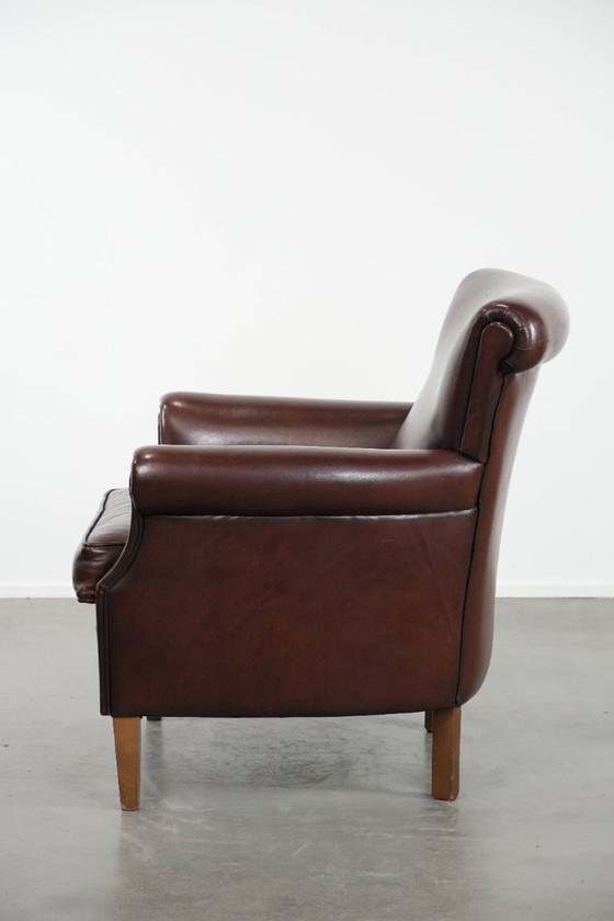 Image 1 of Donkere luxe schapenleren fauteuil/ armchair met een tijdloze uitstraling