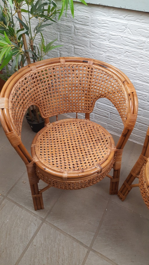 Set di 2 poltrone vintage in rattan con seduta e schienale intrecciati.