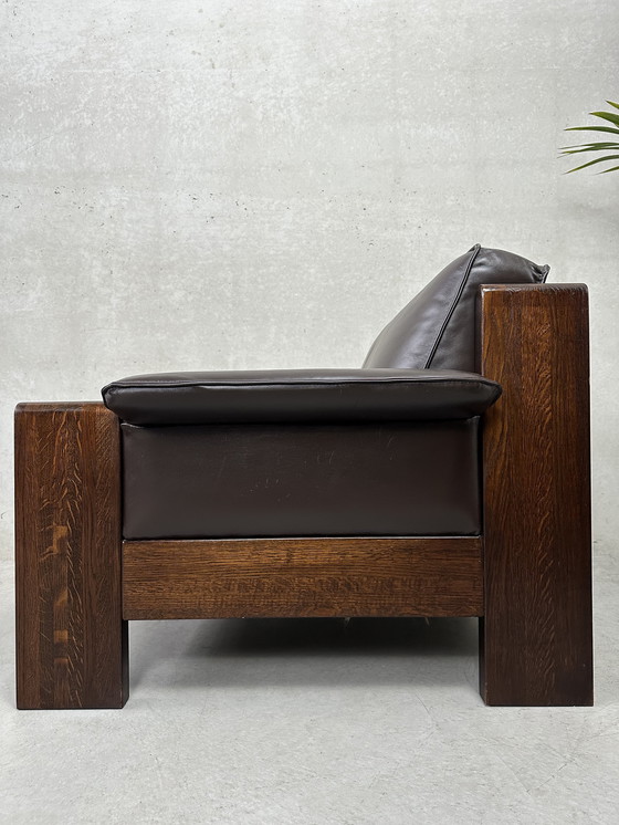 Image 1 of Vintage Leolux bruinkleurige lederen/eiken ‘Lounge chair and ottoman’ van Harry de Groot - 1970