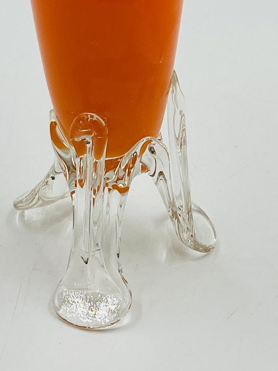 Image 1 of Vintage orange glass bud vase with a sculpted base