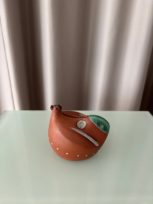Ceramic bird-shaped piggy bank, terracotta and green