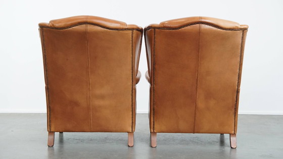 Image 1 of 2x Rundleren oorfauteuil afgewerkt met siernagels