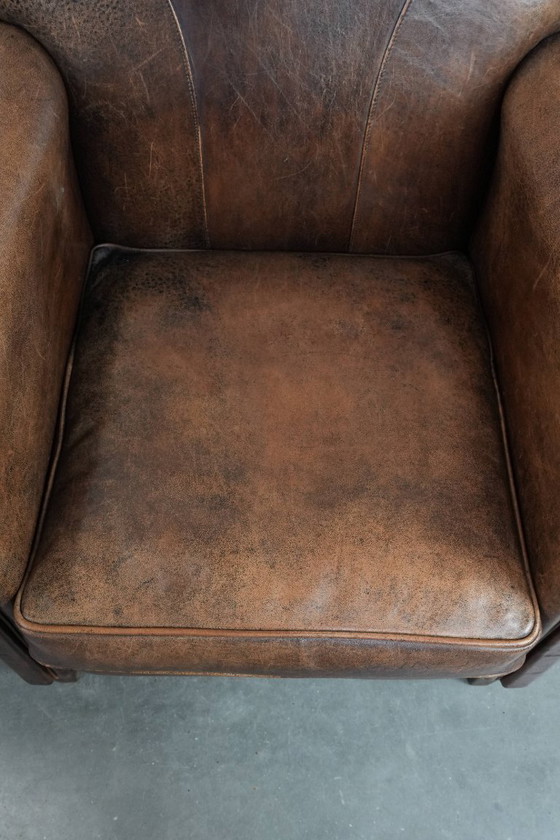Image 1 of 2 x Vintage sheepskin armchair with warm colours and a characterful appearance