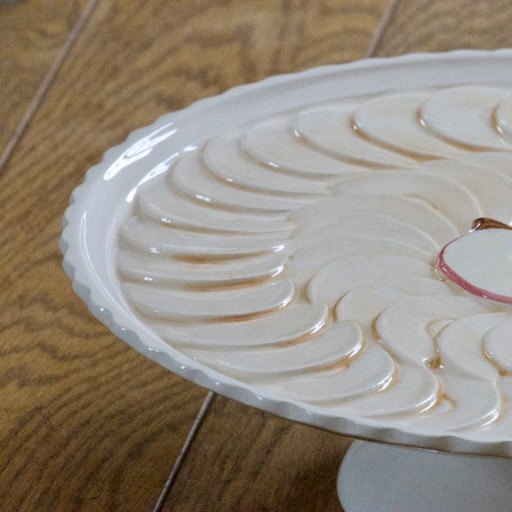 Large earthenware pie dish on a pedestal, apple pie