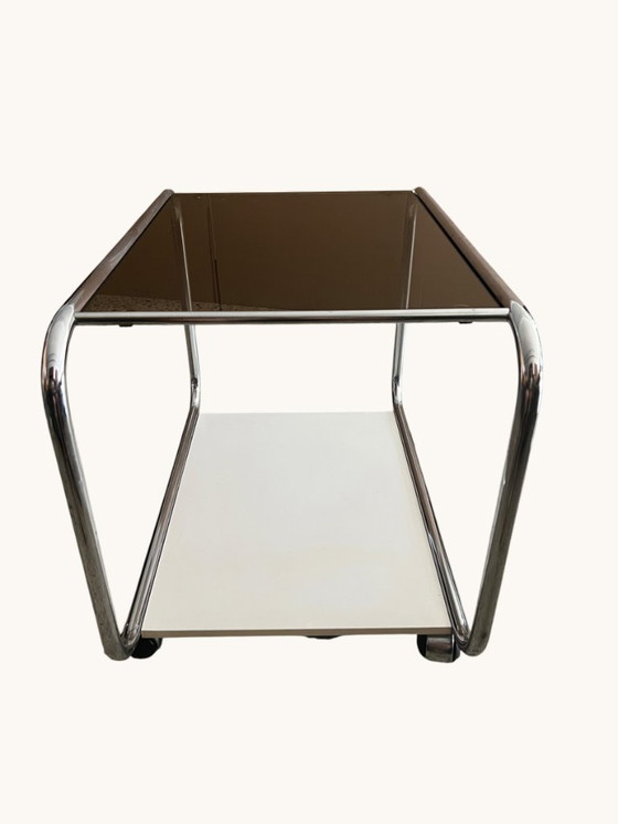 Image 1 of Vintage Space Age side table made of chrome and smoked glass. Sculptural 70s design with wheels.