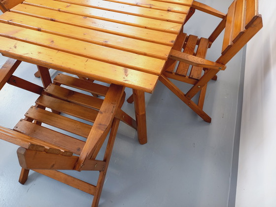 Image 1 of Vintage garden furniture consisting of a table with extensions and 4 wooden armchairs from the 60s