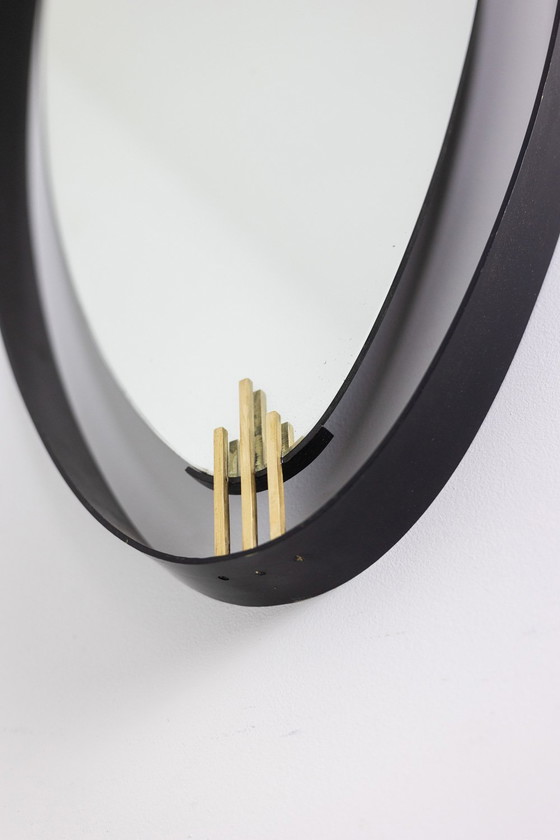 Image 1 of Lacquered and patinated brass mirror, ovoid shape. Circa 1950/60.