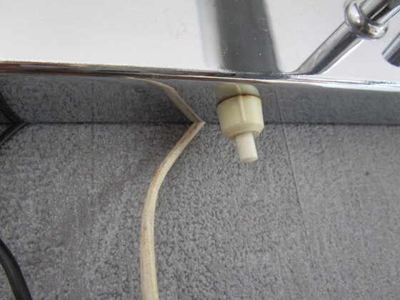 Image 1 of This chrome-colored space-age wall lamp is attributed to designer Gaetano Sciolari from the 1970s.