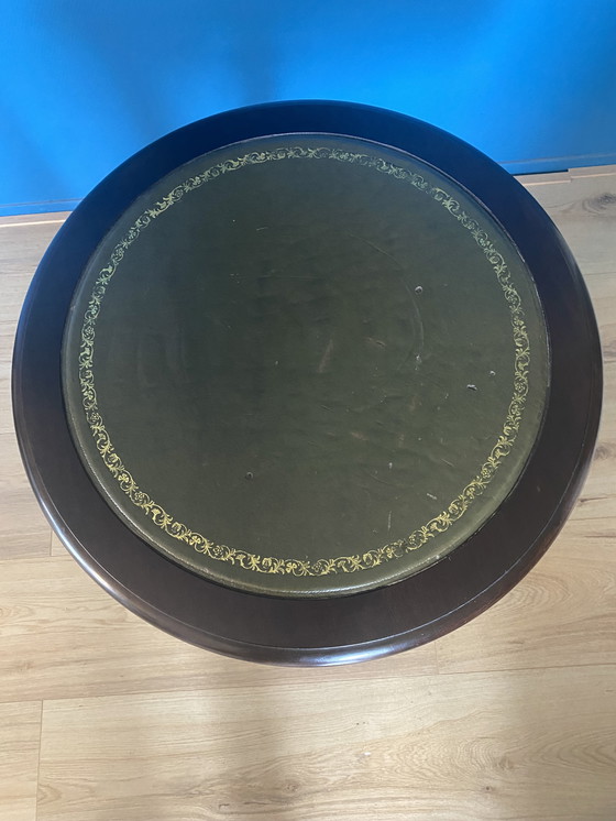 Image 1 of 1 Vintage round side/ wine table with leather top upholstery.
