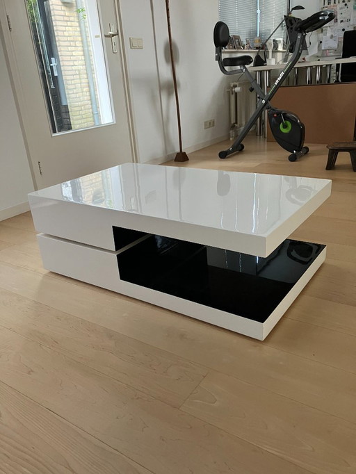 Table basse pivotante blanche/noire brillante