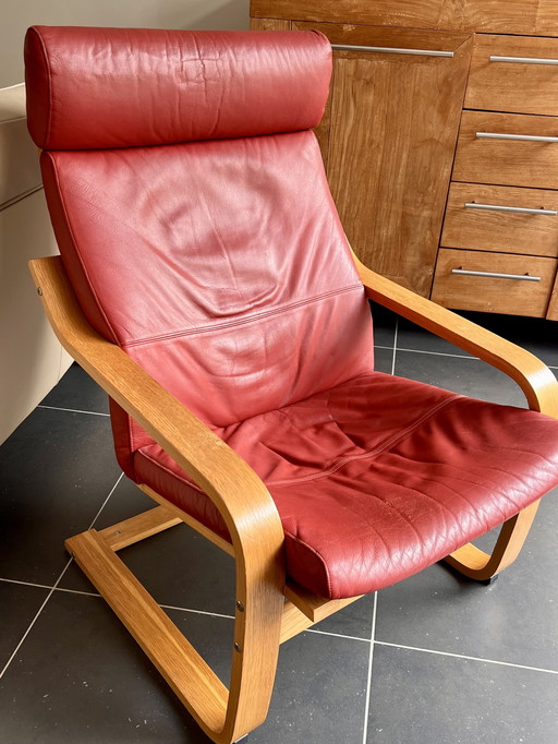 Red leather armchair with footstool