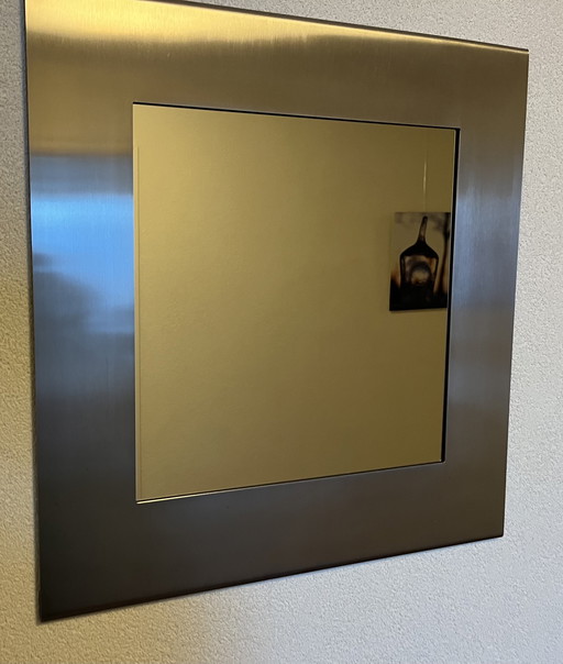 Design mirror in sleek stainless steel frame