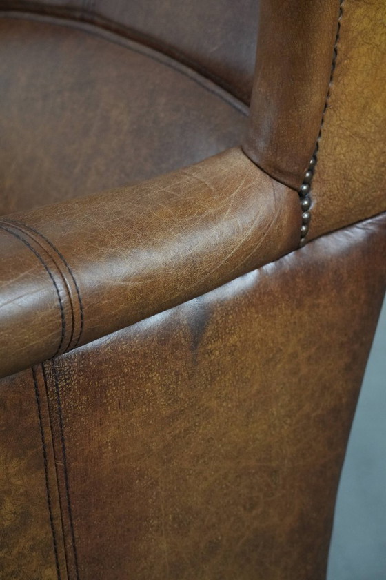 Image 1 of Tijdloze cognac kleurige oorfauteuil in Engelse stijl gemaakt van rundleer afgewerkt met siernagels