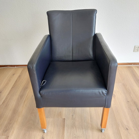 Image 1 of Set of 4 blue leather adjustable dining armchairs with wooden legs (on wheels)