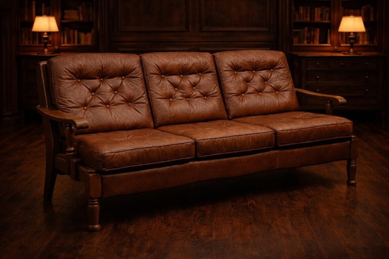 Image 1 of A vintage brown three-piece sofa set in leather with wooden armrests and turned legs, comprising a 1-seater, 2-seater and 3-seat