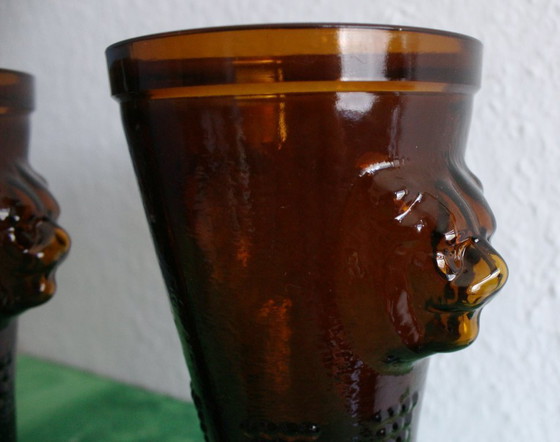 Image 1 of Antique wine tankard made of heavy amber glass with lion heads and paws