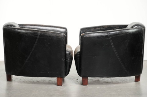 2x rugged black vintage cowhide Aviator design armchairs with a distinctive look