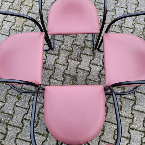 Image 1 of This is a set of four vintage 'Memphis' style chairs with a black metal frame and burgundy upholstery.