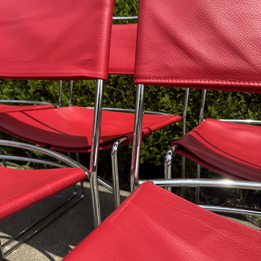 Red Delfina chairs by Enzo Mari