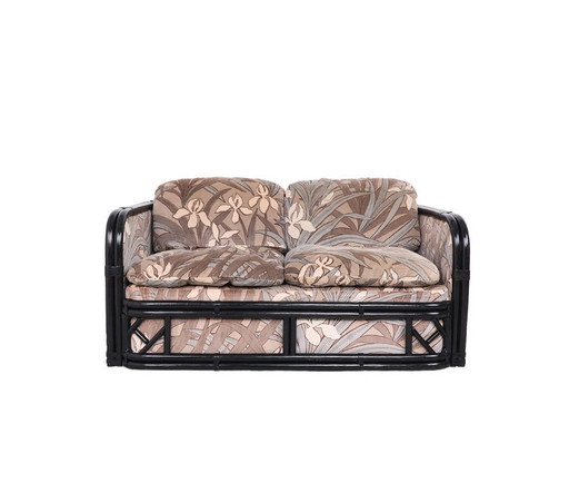 Banco vintage de bambú con tela de terciopelo floral.