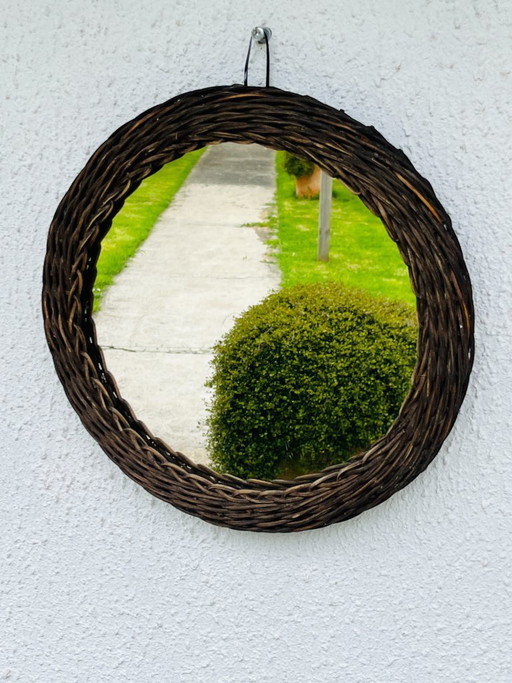 Espejo vintage con forma de sol, hecho de mimbre tejido.