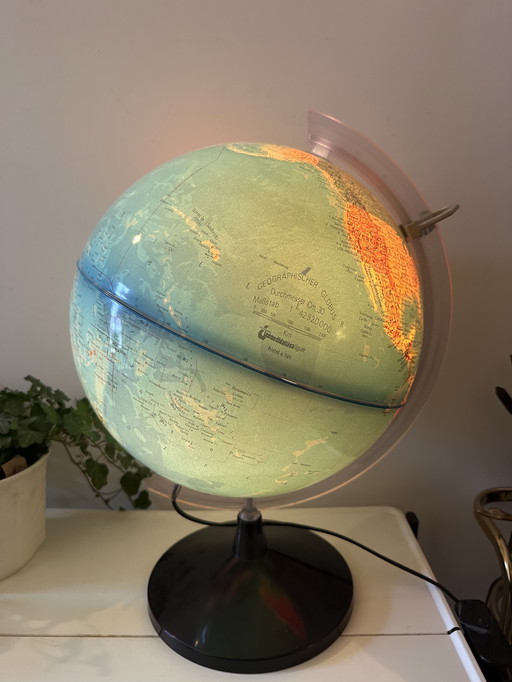 Globe with light and magnifying glass