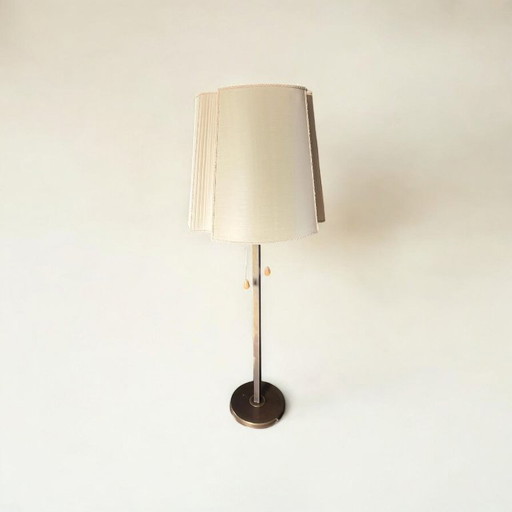 Impressive Art Deco floor lamp made of patinated brass, height-adjustable with classically shaped textile lampshade