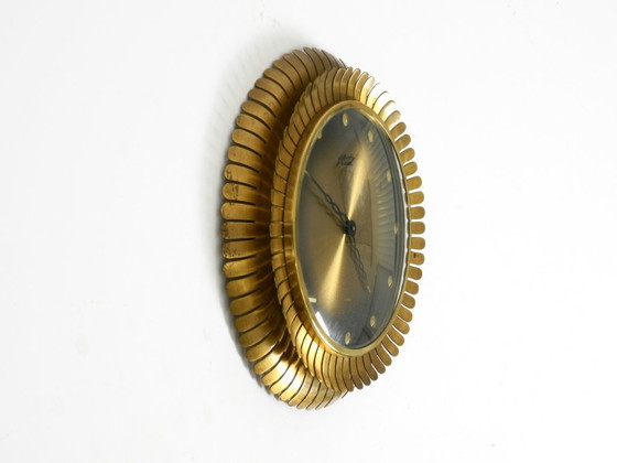 Image 1 of Beautiful original Mid Century Sunburst Atlanta Universe wall clock made of heavy brass with a mechanical seven-day movement