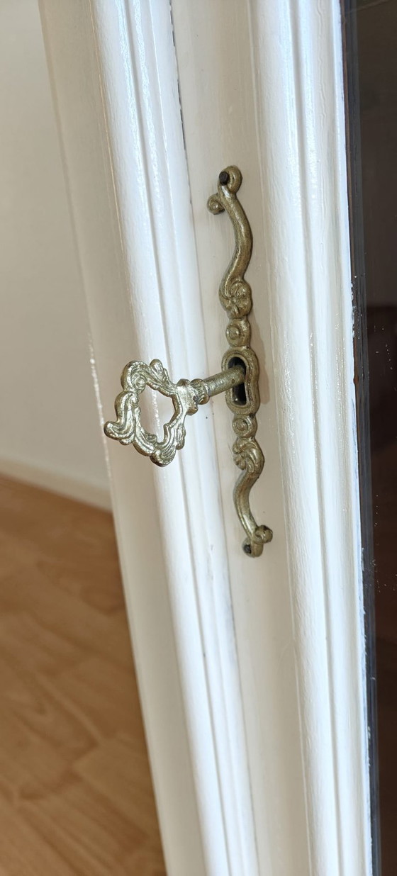 Image 1 of Mueble esquinero blanco restaurado con detalles en marrón oscuro.