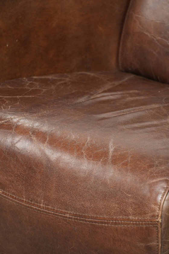Image 1 of Karaktervolle en stoere donker cognac bruine rundleren Aviator design fauteuil/ armchair met een interessante vorm