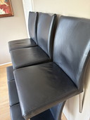 6 zwart leren eetkamerstoelen met rvs poten