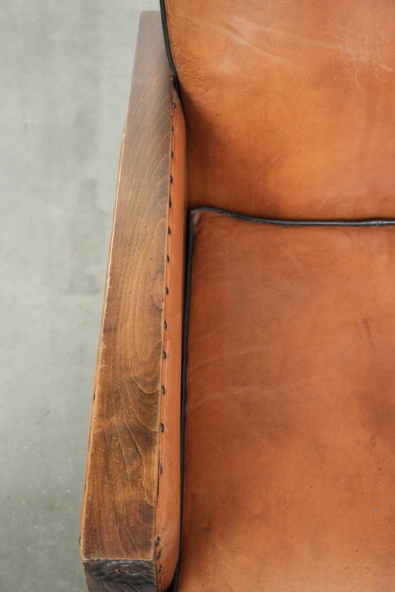 Image 1 of 2 x Prachtige schapenleren Art Deco fauteuil met mooi houtsnijwerk en zwarte biezen