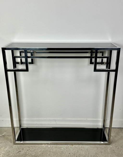 Consola estilo Art Déco en metal cromado con tablero de cristal negro