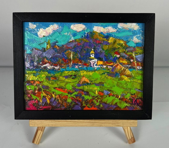 Image 1 of Peinture à l'huile originale représentant un paysage rural. Un village se dessine au loin.