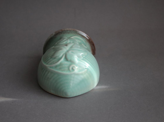 Image 1 of Lichtgroene vintage keramische wandvaas met wijnrankdecoratie.
