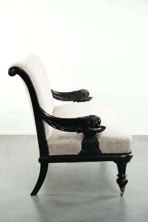 Luxurious 19th-century French sofa in Empire style with cream-colored fabric and uniquely detailed armrests. (photo 2 of 13)