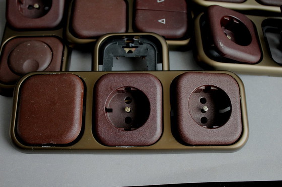Image 1 of Large collection of vintage brown sockets and light switches with antique gold frames, 1960s/70s