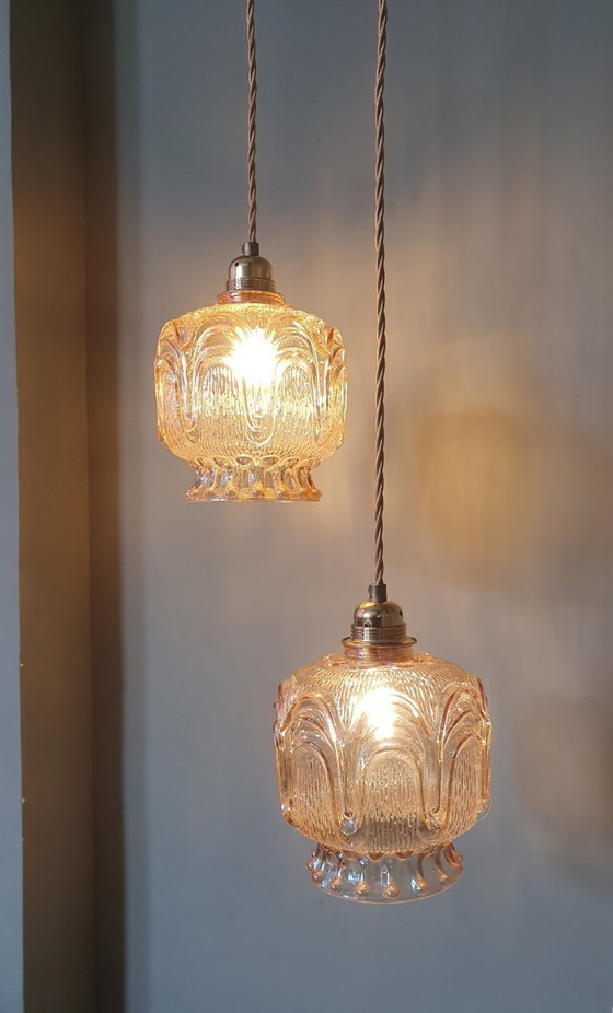 Image 1 of Set of 2 Vintage textured rose / amber tinted pendant lamps - mid-century design.