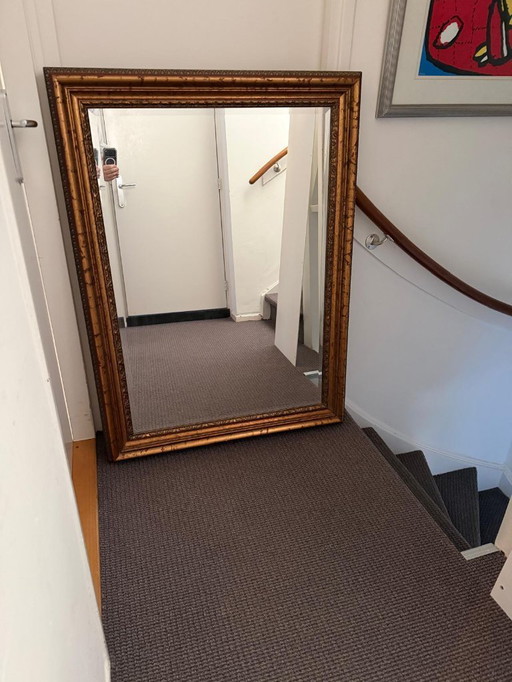 Large classic mirror with a gold-colored ornamental frame – statement piece