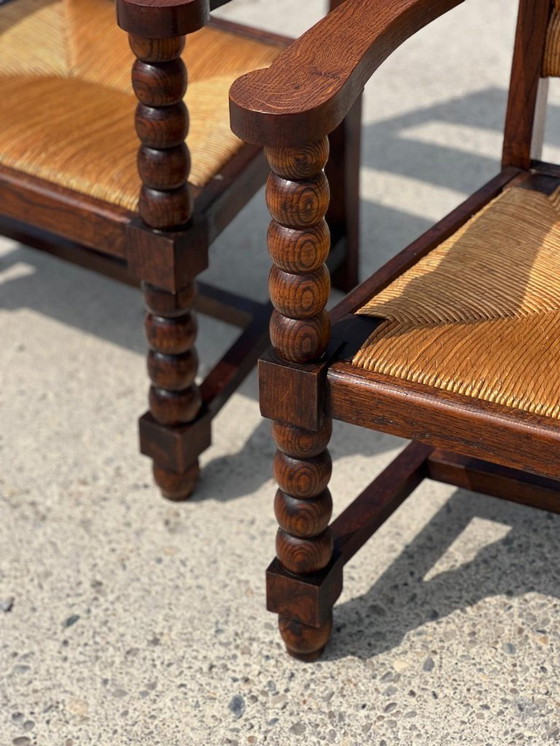 Image 1 of Coppia di poltrone in rovere tinto e paglia, opera francese 1950