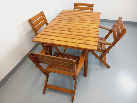 Image 1 of Vintage garden furniture consisting of a table with extensions and 4 wooden armchairs from the 60s