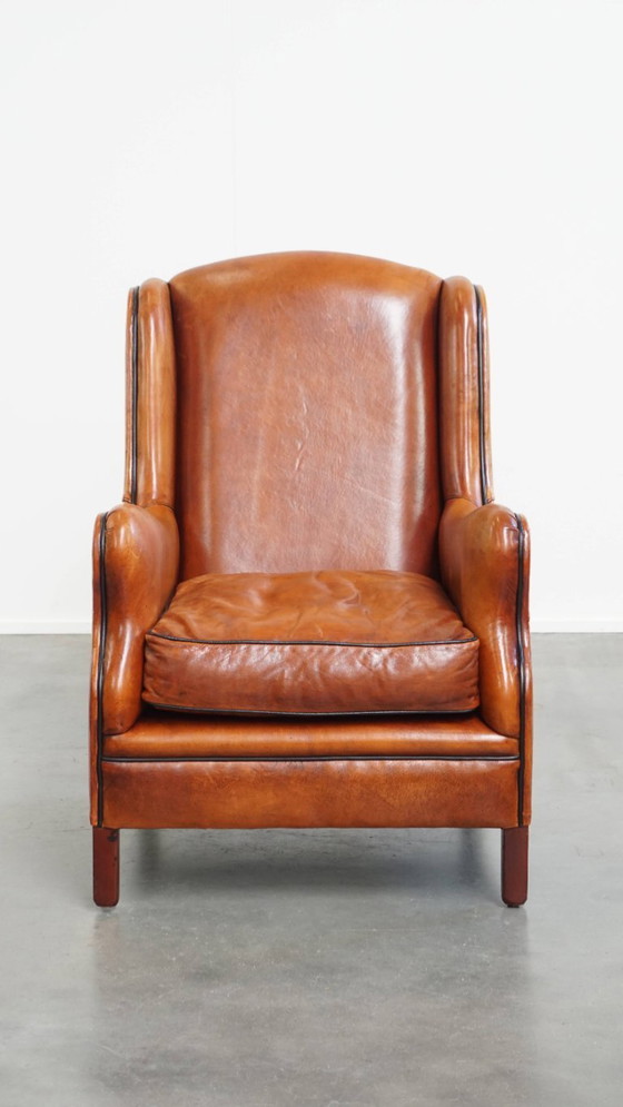 Image 1 of Schapenleren armchair met hoge rug en zwarte biezen 