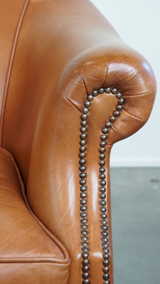 Image 1 of 2 x Cognacfarbener Rindsleder-Clubsessel mit dekorativem Nagelfinish