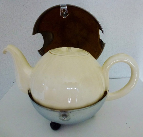 Image 1 of Ceramic Teapot with thermal Chrome casing which keeps the contents hot (or cold).
