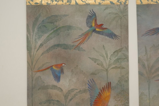 Image 1 of Contemporary painted canvas depicting parrots in a tropical forest.