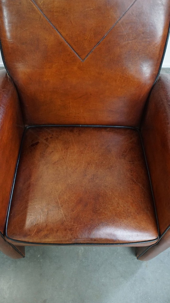 Image 1 of 6 x Vintage sheepskin dining chair with black piping on wheels