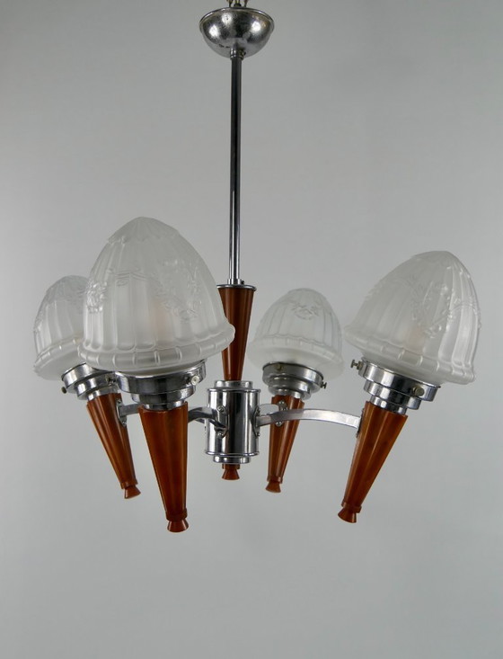 Image 1 of Chrome Art Deco chandelier with four amber Bakelite torches with decorated glass lampshades, ca. 1935