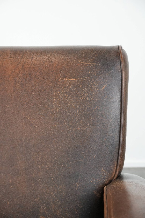 Image 1 of Tijdloze vintage schapenleren design fauteuil in een donkere cognac kleur